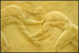 Wrestlers depicted in a Grecian frieze